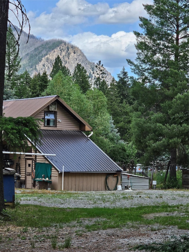 64 Ponderosa Ln, Thompson Falls, MT 59873 - view of home's exterior with a mountain view and a metal roof