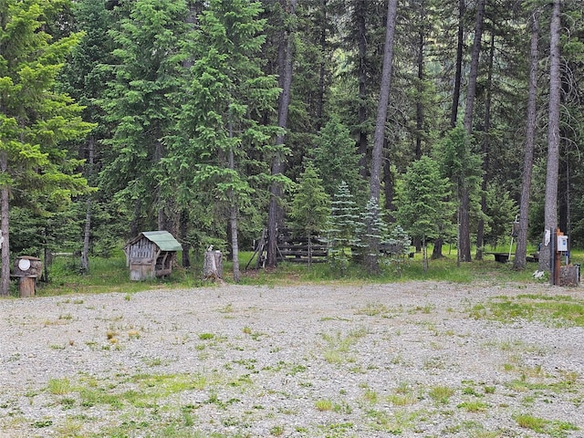 64 Ponderosa Ln, Thompson Falls, MT 59873 - view of yard with a storage unit and a wooded view