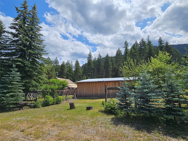 64 Ponderosa Ln, Thompson Falls, MT 59873 - view of green lawn featuring a view of trees and an outbuilding
