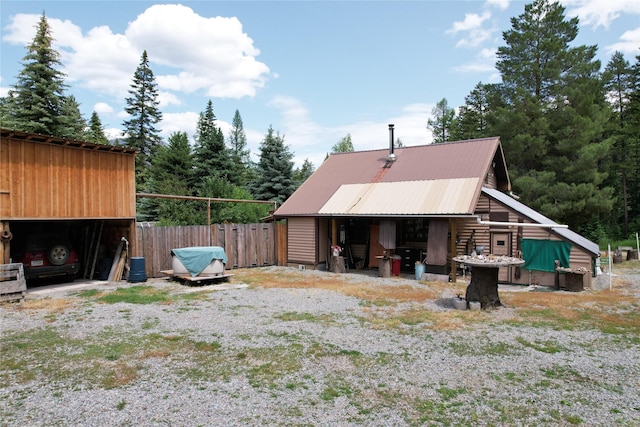 64 Ponderosa Ln, Thompson Falls, MT 59873 - rear view of property with a metal roof and an outbuilding