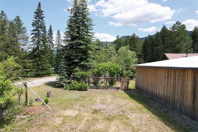 64 Ponderosa Ln, Thompson Falls, MT 59873 - view of green lawn featuring a wooded view