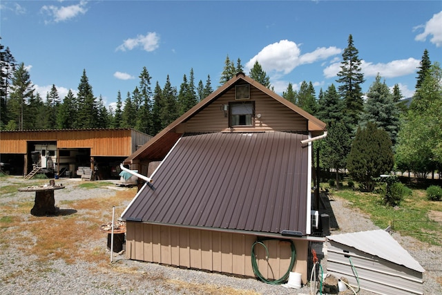 64 Ponderosa Ln, Thompson Falls, MT 59873 - view of property exterior featuring a metal roof, an outbuilding, and a pole building