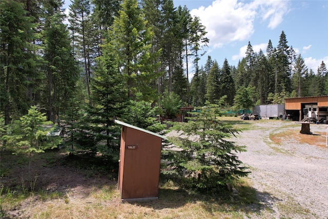 64 Ponderosa Ln, Thompson Falls, MT 59873 - view of dirt / gravel driveway featuring a forest view