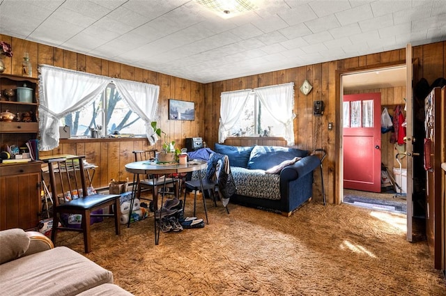 628 Kelley Rd, Columbia Falls, MT 59912 - carpeted living area with healthy amount of natural light and wooden walls