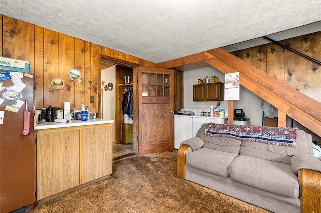 628 Kelley Rd, Columbia Falls, MT 59912 - living room featuring dark carpet, washing machine and dryer, and wood walls