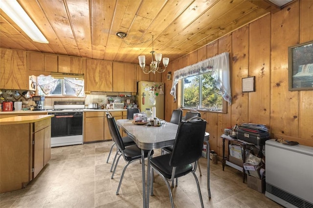 628 Kelley Rd, Columbia Falls, MT 59912 - dining area featuring wood ceiling, a chandelier, wooden walls, and healthy amount of natural light