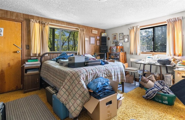 628 Kelley Rd, Columbia Falls, MT 59912 - bedroom with a textured ceiling and wooden walls