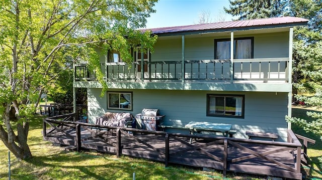 628 Kelley Rd, Columbia Falls, MT 59912 - back of property with a balcony, a lawn, and a metal roof