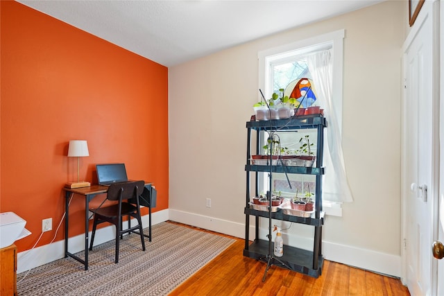 office space featuring wood finished floors and baseboards