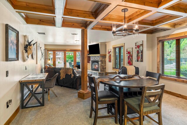 dining room with coffered ceiling, a wealth of natural light, carpet, and baseboards