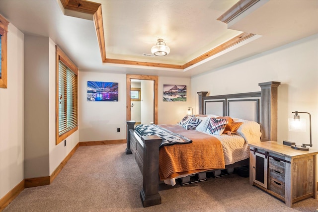 bedroom with baseboards, light carpet, visible vents, and a raised ceiling