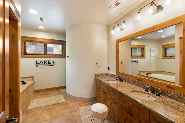 full bath featuring visible vents, double vanity, a bath, and a sink
