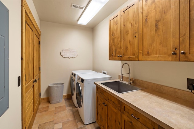 laundry room featuring stone finish floor, a sink, visible vents, separate washer and dryer, and cabinet space
