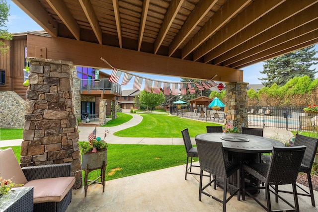 view of patio featuring outdoor dining space and fence