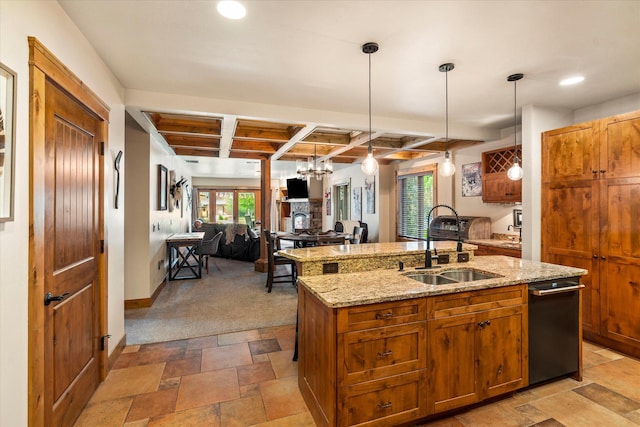 kitchen featuring beam ceiling, a wealth of natural light, a kitchen island with sink, and a sink