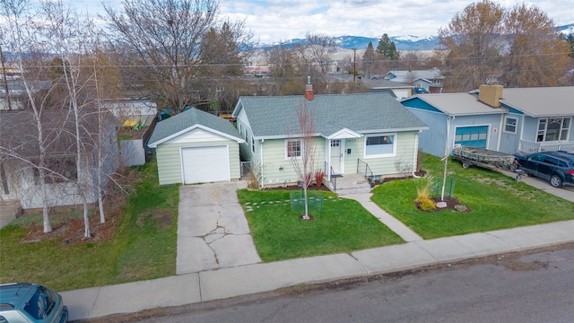 1634 W Central Ave, Missoula, MT 59801 - bungalow with a chimney, a front lawn, driveway, and a detached garage