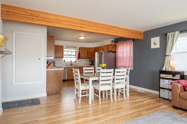 1634 W Central Ave, Missoula, MT 59801 - dining space with light wood-style flooring, baseboards, and beamed ceiling