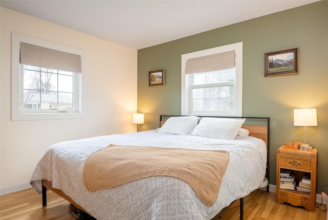 1634 W Central Ave, Missoula, MT 59801 - bedroom featuring multiple windows, light wood finished floors, and baseboards
