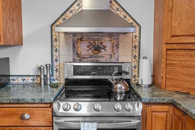 538 Bighorn Dr, Thompson Falls, MT 59873 - kitchen with stainless steel electric range oven, dark countertops, wall chimney exhaust hood, and brown cabinets