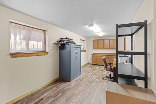 538 Bighorn Dr, Thompson Falls, MT 59873 - home office featuring a textured ceiling, light wood finished floors, and baseboards