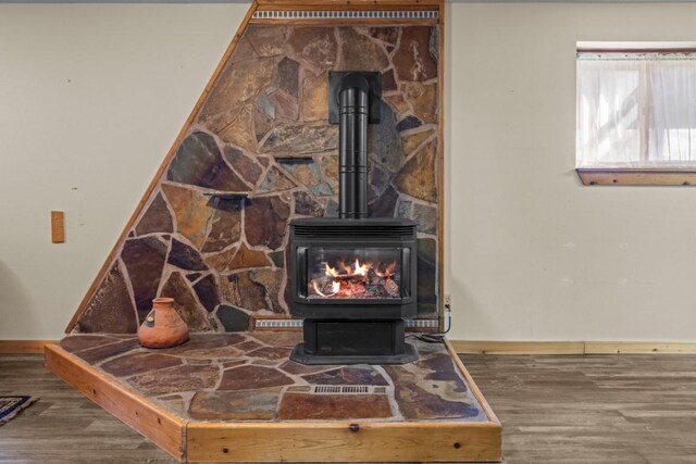 538 Bighorn Dr, Thompson Falls, MT 59873 - interior details with wood finished floors, a wood stove, and baseboards