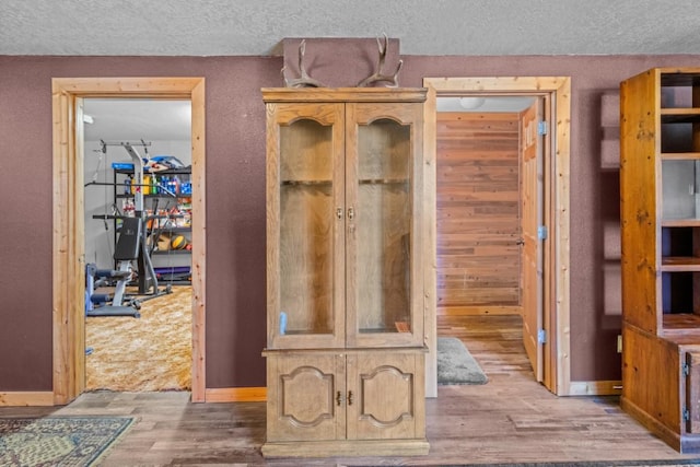 538 Bighorn Dr, Thompson Falls, MT 59873 - mudroom featuring a textured ceiling, wood finished floors, and baseboards