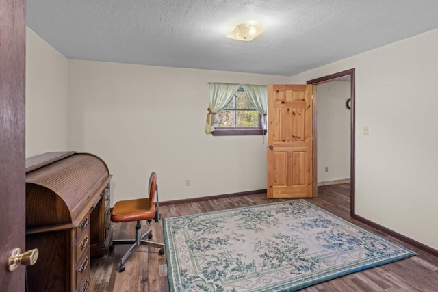 538 Bighorn Dr, Thompson Falls, MT 59873 - office with baseboards, a textured ceiling, and wood finished floors