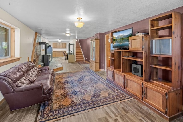 538 Bighorn Dr, Thompson Falls, MT 59873 - living room featuring stairs, a textured ceiling, and wood finished floors