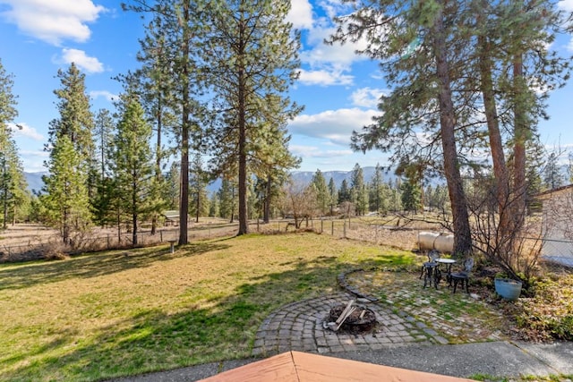 538 Bighorn Dr, Thompson Falls, MT 59873 - view of yard featuring a patio, a fenced backyard, and a mountain view