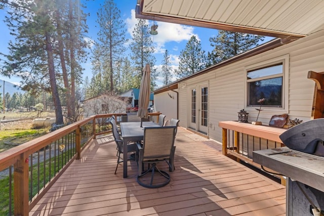 538 Bighorn Dr, Thompson Falls, MT 59873 - wooden deck with french doors and outdoor dining area