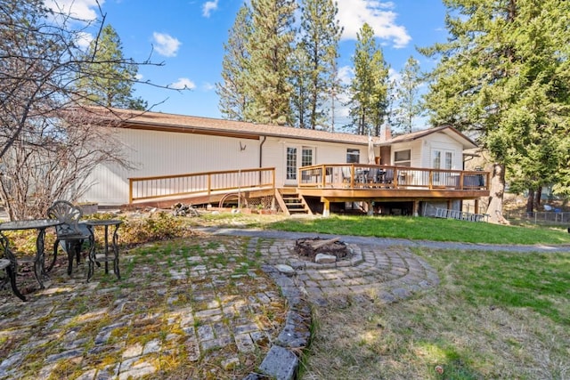 538 Bighorn Dr, Thompson Falls, MT 59873 - back of house with an outdoor fire pit, a deck, and a lawn