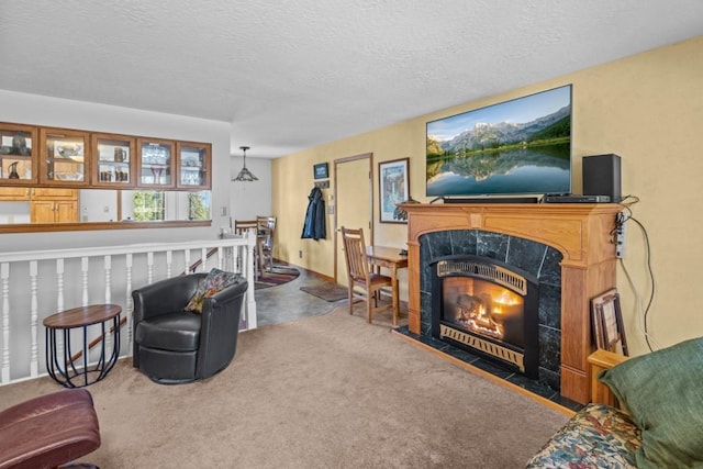 538 Bighorn Dr, Thompson Falls, MT 59873 - living area with a textured ceiling, carpet flooring, and a tiled fireplace