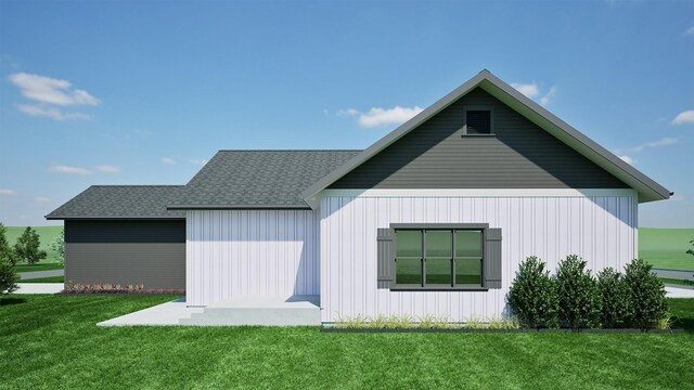 view of home's exterior featuring a yard and roof with shingles