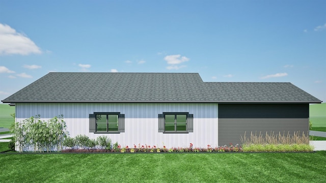 view of side of property featuring a yard and a shingled roof