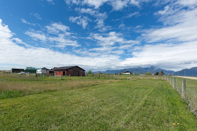 716 Shadow Dancer Way, Stevensville, MT 59870 - view of yard featuring a view of rural / pastoral area, a mountain view, an outbuilding, and a pole building