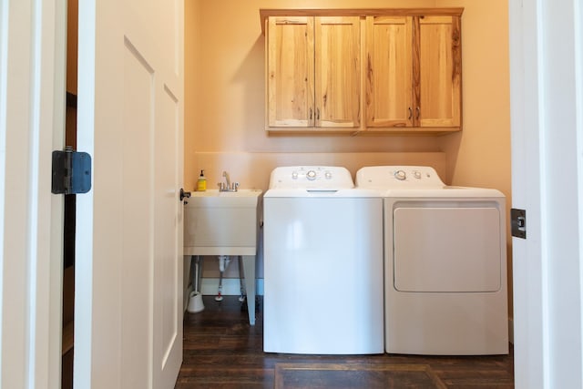 716 Shadow Dancer Way, Stevensville, MT 59870 - laundry room featuring washing machine and clothes dryer, cabinet space, and dark wood-style flooring