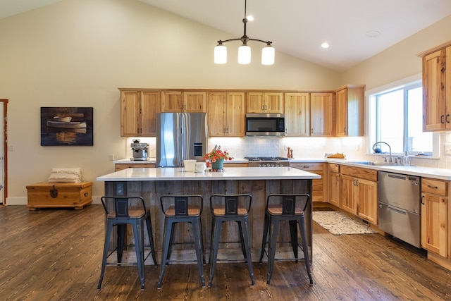 716 Shadow Dancer Way, Stevensville, MT 59870 - kitchen with appliances with stainless steel finishes, dark wood-style flooring, light countertops, backsplash, and high vaulted ceiling