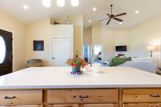 716 Shadow Dancer Way, Stevensville, MT 59870 - kitchen with ceiling fan, high vaulted ceiling, a center island, light stone counters, and open floor plan