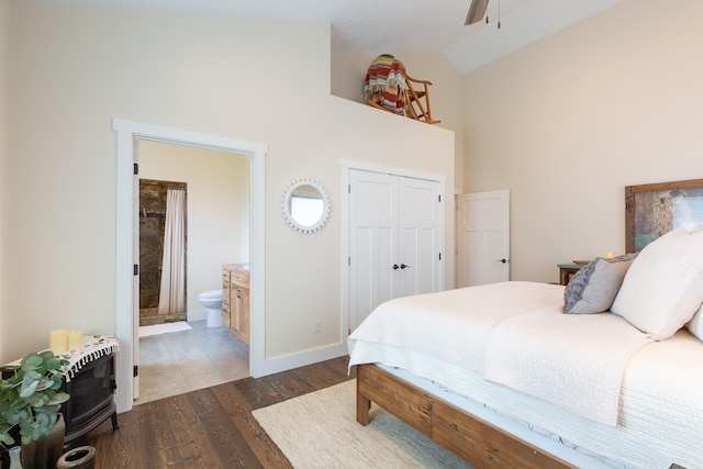 716 Shadow Dancer Way, Stevensville, MT 59870 - bedroom featuring high vaulted ceiling, wood finished floors, a closet, and ensuite bath