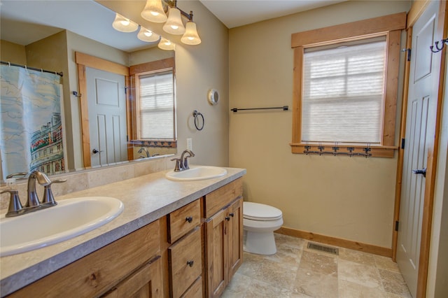 3774 Juliet Dr, Helena, MT 59602 - full bathroom with baseboards, visible vents, toilet, and a sink