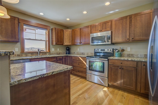 3774 Juliet Dr, Helena, MT 59602 - kitchen featuring recessed lighting, light stone countertops, a sink, light wood-type flooring, and appliances with stainless steel finishes