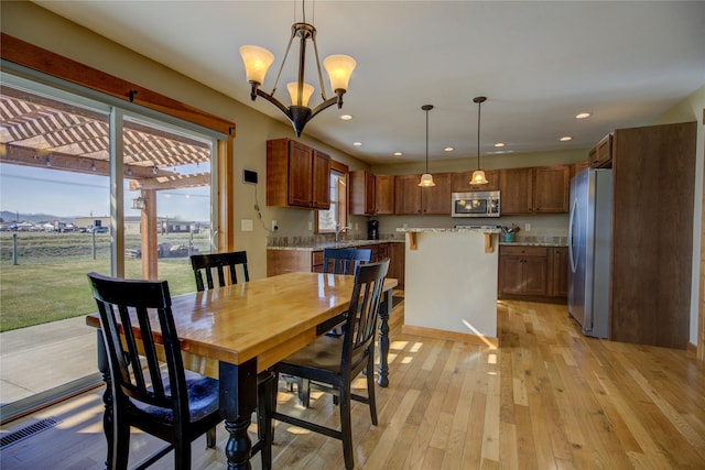 3774 Juliet Dr, Helena, MT 59602 - dining area featuring an inviting chandelier, light wood-style floors, recessed lighting, and visible vents