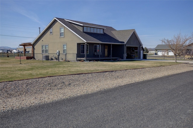 3774 Juliet Dr, Helena, MT 59602 - view of front of house with board and batten siding, fence, driveway, a front yard, and an attached garage