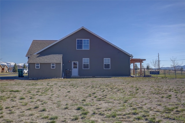 3774 Juliet Dr, Helena, MT 59602 - back of property with fence, a pergola, and a mountain view