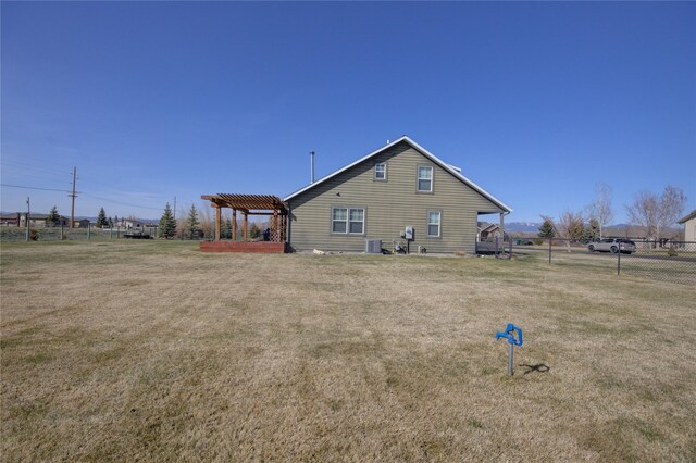 3774 Juliet Dr, Helena, MT 59602 - view of property exterior featuring a pergola, a lawn, central AC, and fence