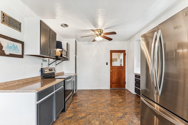 14668 Shore Acres Dr, Bigfork, MT 59911 - kitchen with stainless steel appliances, a ceiling fan, stone finish flooring, and light countertops