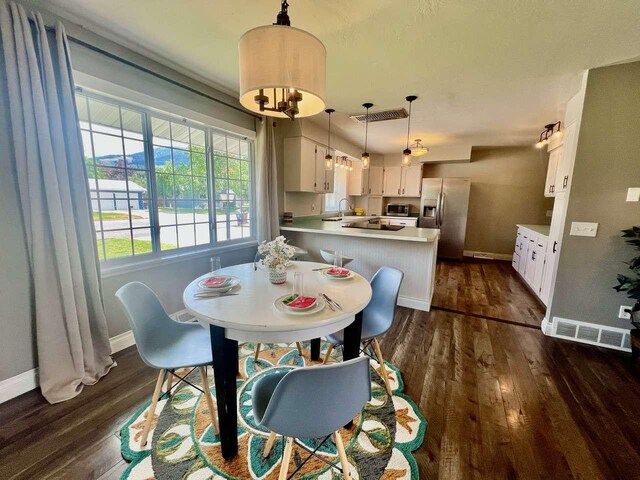 4217 Larkspur Dr, Missoula, MT 59803 - unfurnished bedroom with baseboards, a walk in closet, wood finished floors, and multiple windows