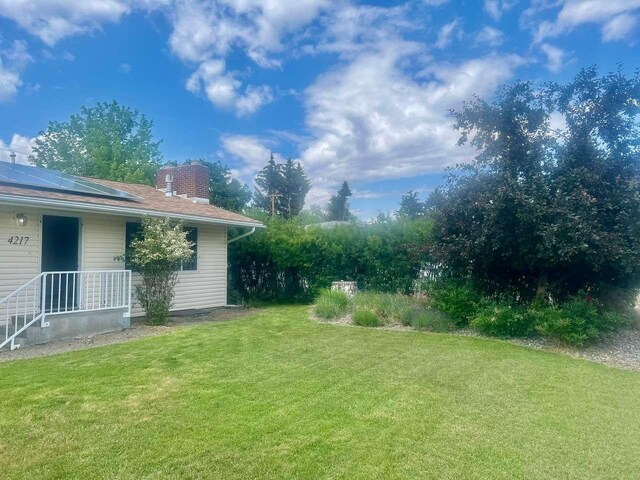 4217 Larkspur Dr, Missoula, MT 59803 - view of yard with a storage shed, an outbuilding, fence, and a vegetable garden