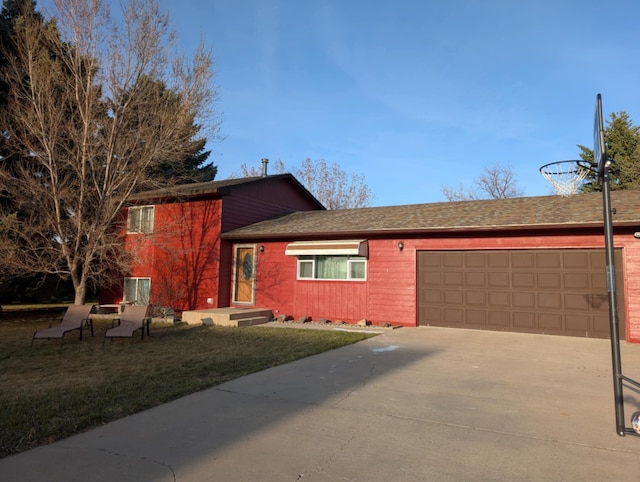 2599 Pike Dr, East Helena, MT 59635 - tri-level home with roof with shingles, an attached garage, driveway, and a front lawn