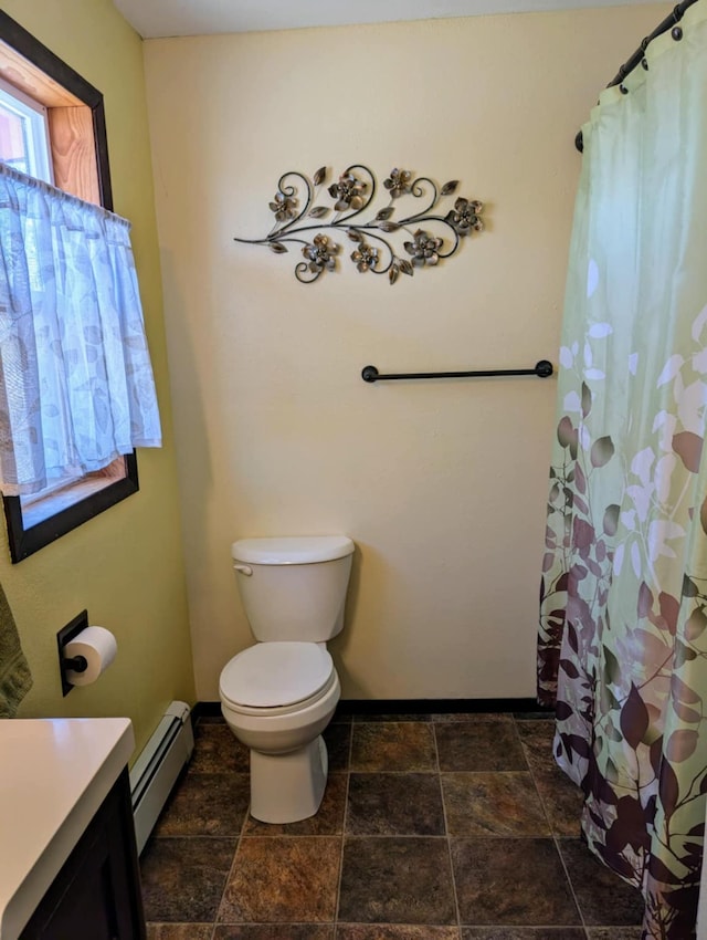 2599 Pike Dr, East Helena, MT 59635 - full bathroom featuring stone finish floor, vanity, a baseboard radiator, and toilet